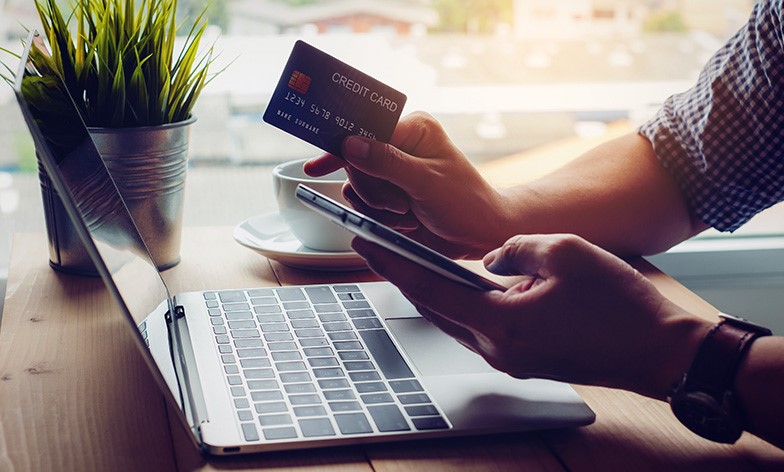 Man holding phone and credit card